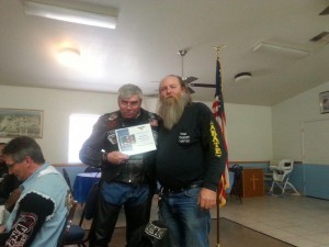 @TekBoss from Motorcycle Safari receives a business membership plaque from High Country Coordinator Wayne Slocum.
